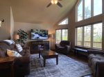 Living area with large windows and flat screen TV 